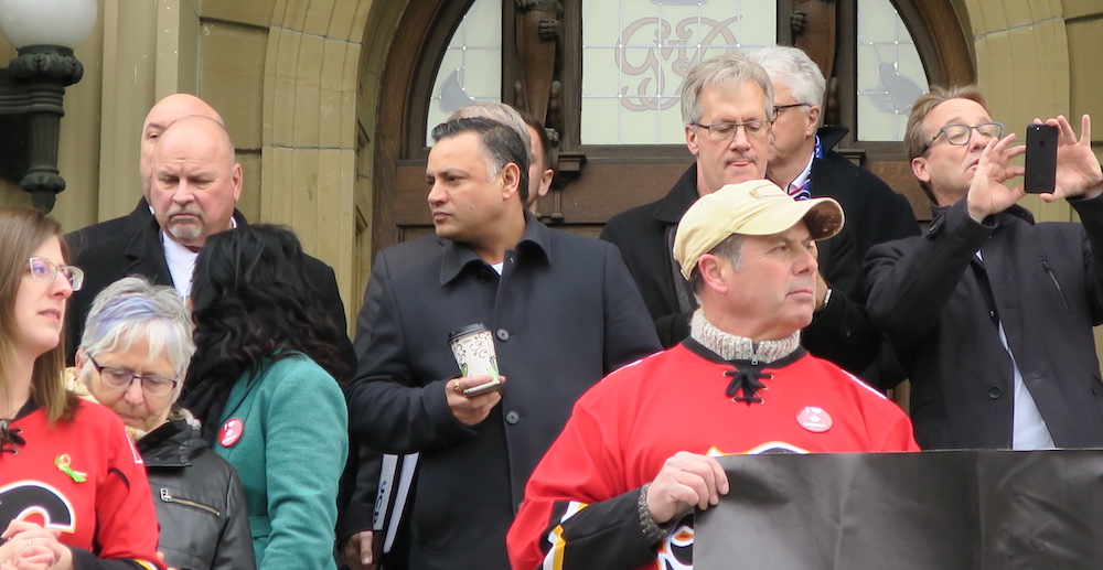 Prab Gill, centre, with coffee and iPhone, along with members of both the NDP and UCP caucuses supporting oilsands pipelines last April (Photo: David J. Climenhaga).