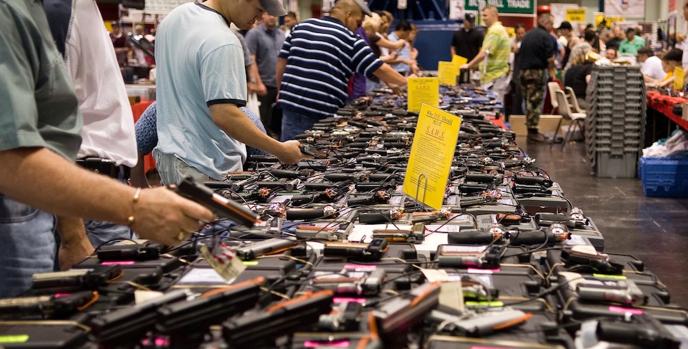 Presumed law-abiding gun owners shop at a gun show in Texas, where no records of sales are kept (Photo: M&R Glasgow, Wikimedia Commons).