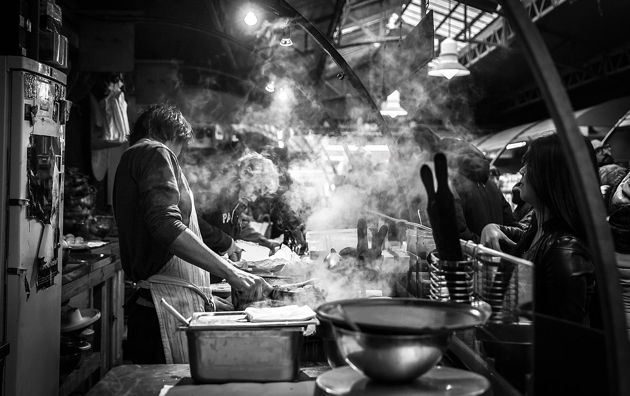 Workers in a steamy kitchen preparing food. Photo: John Legrand/Wikimedia Commons