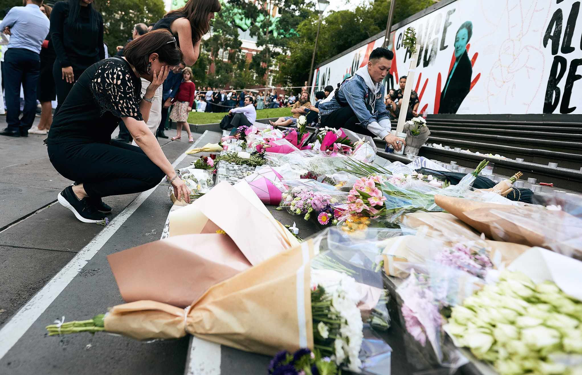 Woman lays wreath at memorial. Photo: julian meehan/Flickr