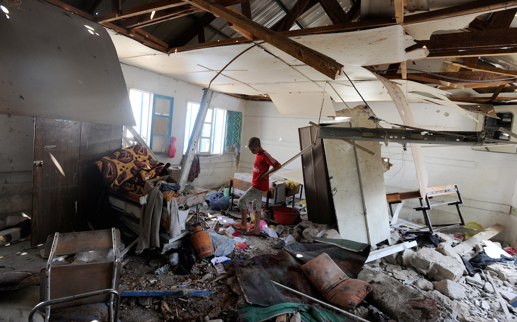 A Palestinian student inspects the damage at a UN school in Gaza. Photo: United Nations Photo/Flickr