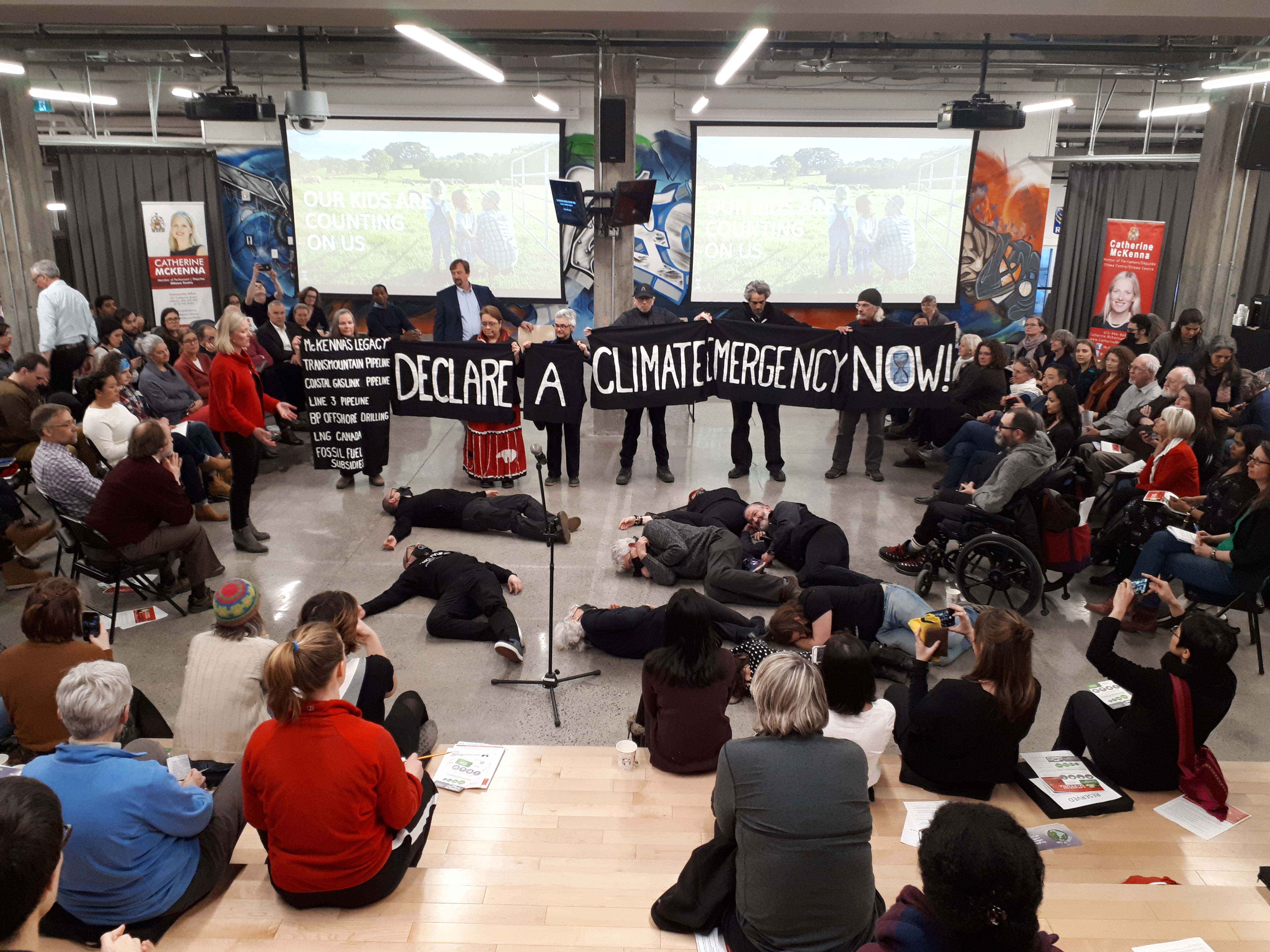 Protesters at a town hall for Catherine McKenna. Photo by Brent Patterson