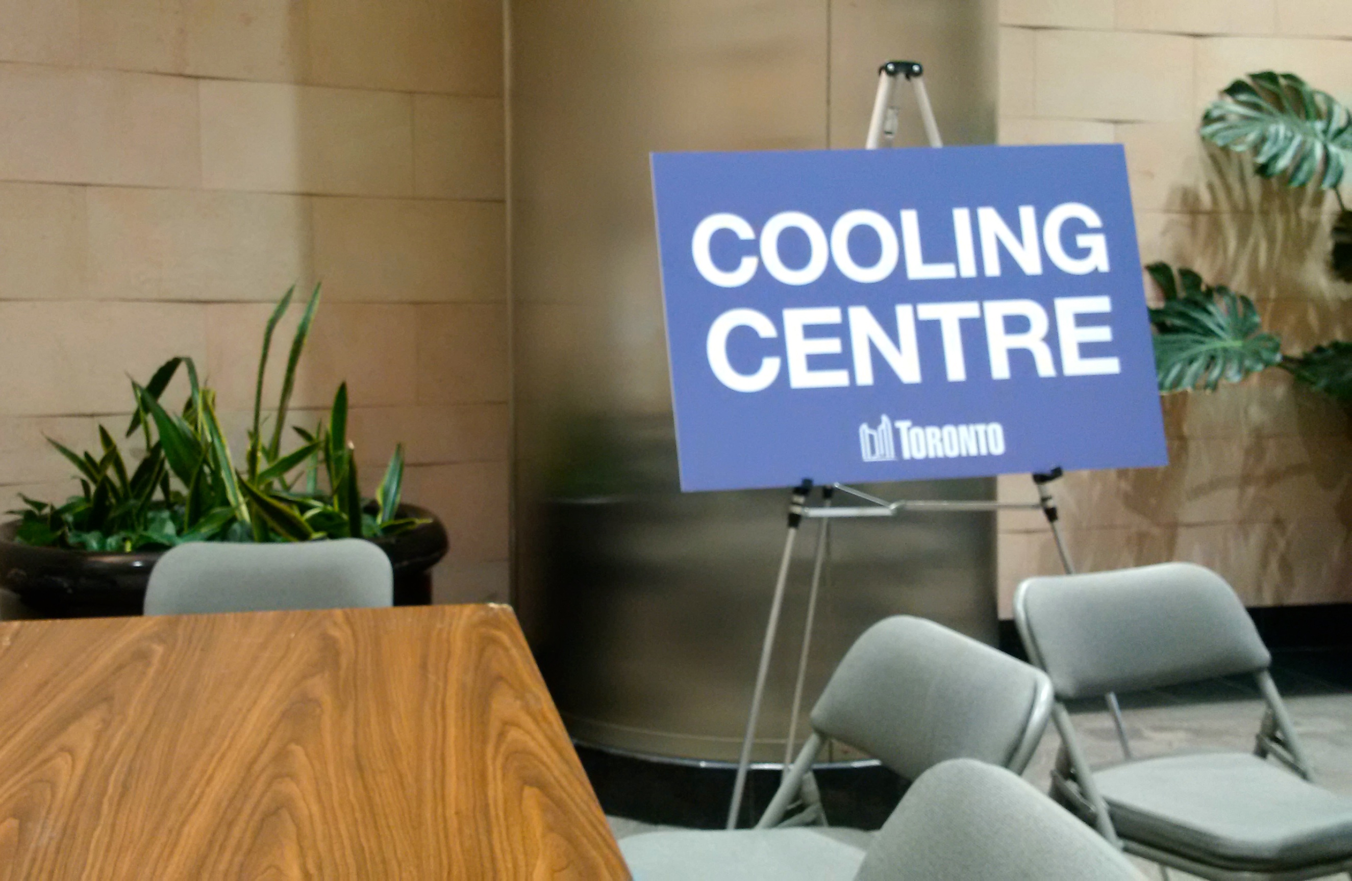 A table and chairs in a hallway with a sign that says Cooling Centre. Image: Cathy Crowe