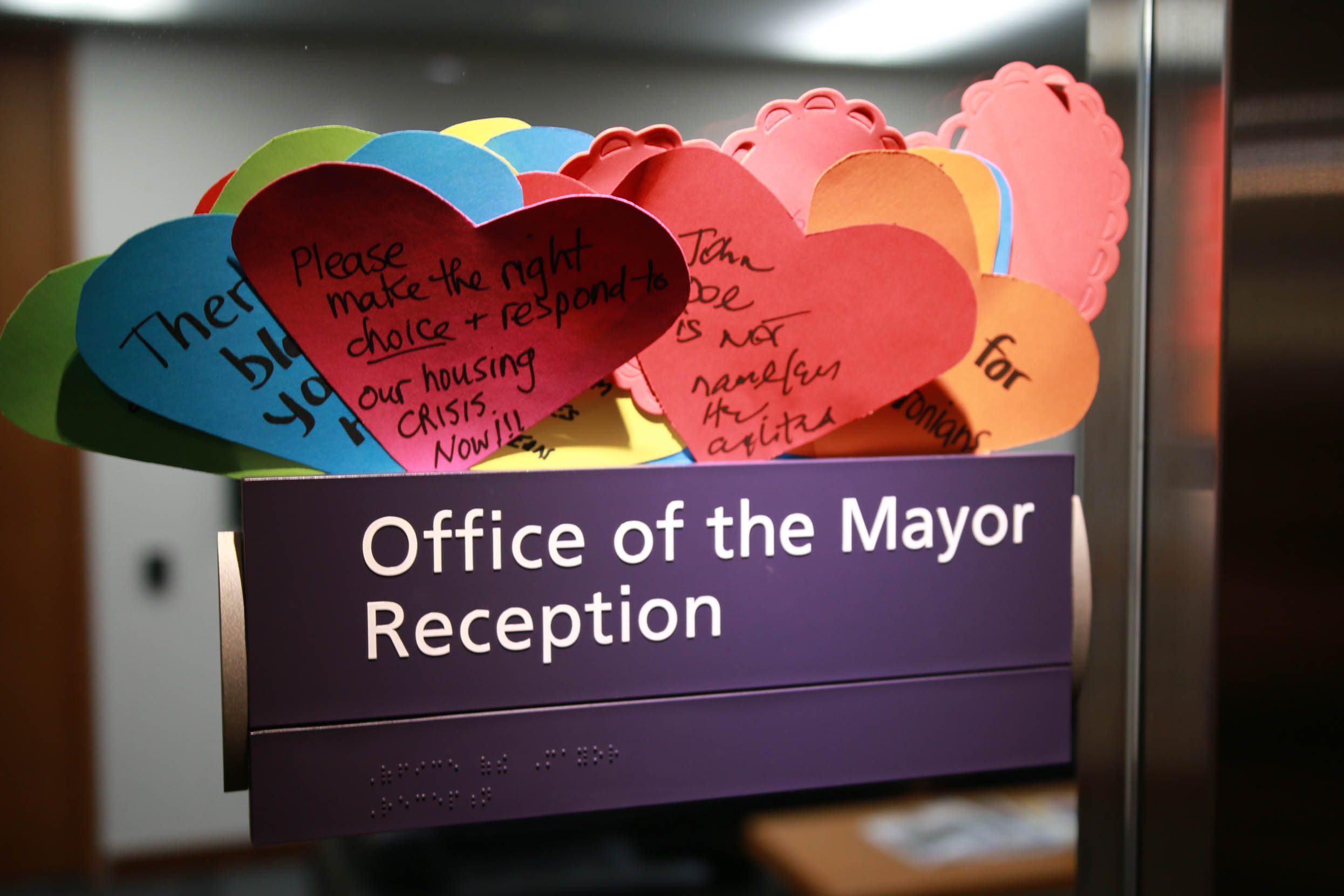 Handwritten hearts are left outside Toronto Mayor's office. One says 'Please make the right choice and respond to our housing crisis now!!' Photo credit: Paul Salvatori