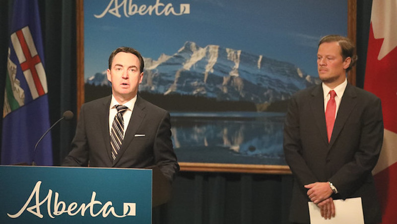 Alberta Labour Minister Jason Copping, left, and minimum wage "expert panel" chair Joseph Marchand at the government's newser in Calgary. Image: Government of Alberta/Flickr