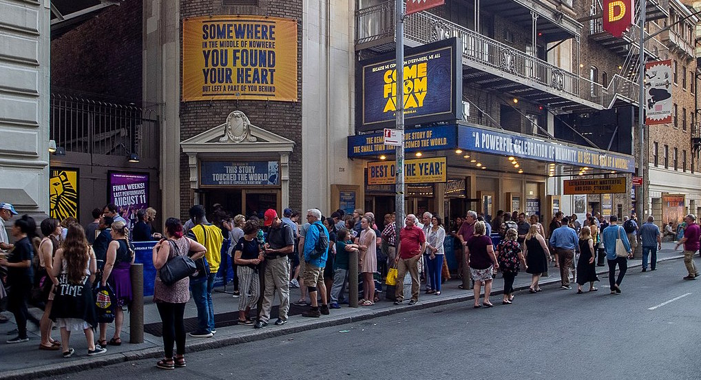 People wait outside Schoenfeld Theater in midtown Manhattan to see Come From Away. Image: Ajay Suresh/Wikimedia Commons