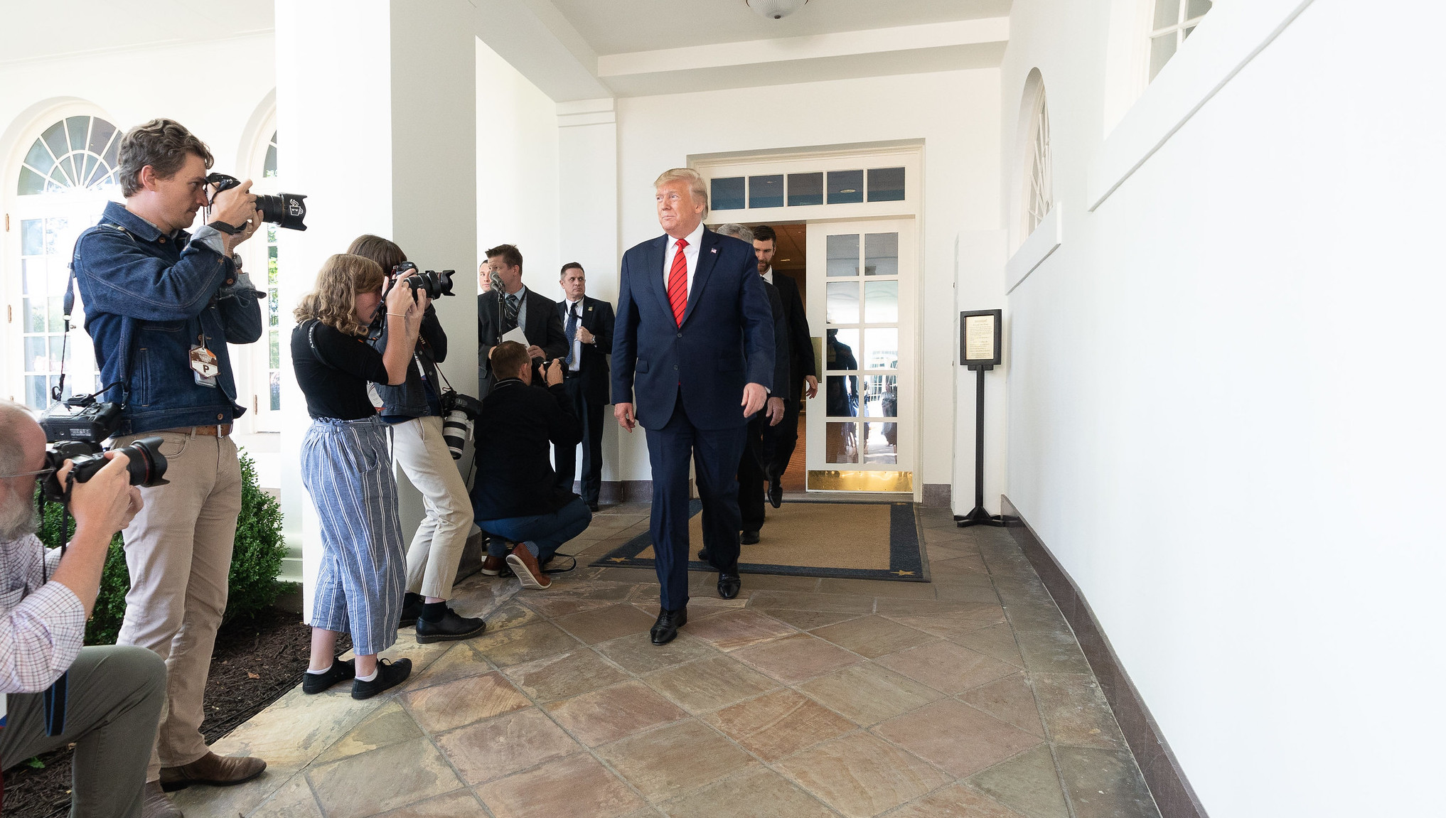 U.S. President Donald Trump walks along the West Wing Colonnade on October 15, 2019. Image: Shealah Craighead/The White House/Flickr