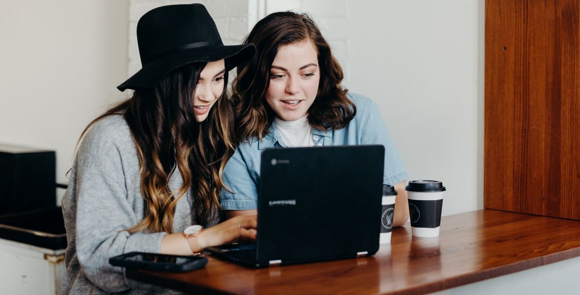 Two people lookign at laptop computer. Image: Brooke Cagle/Unsplash