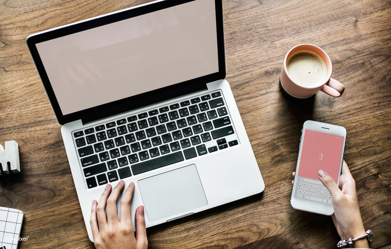 Aerial view of person using computer laptop and a smartphone. Image: Rawpixel Ltd/Flickr