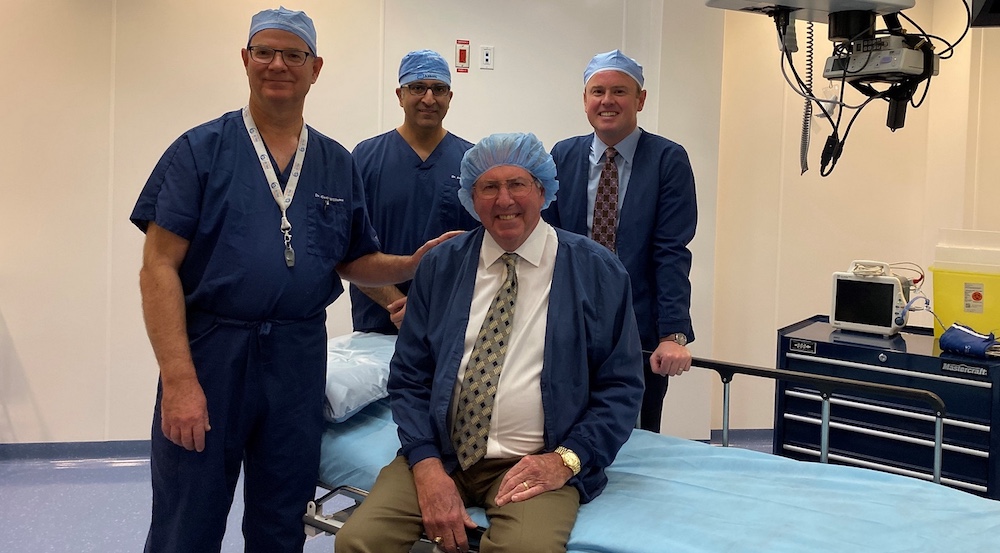 Alberta Health Minister Tyler Shandro, at right, poses with two surgeons and a patient at a private Calgary eye-surgery clinic yesterday. Image: Government of Alberta/Flickr