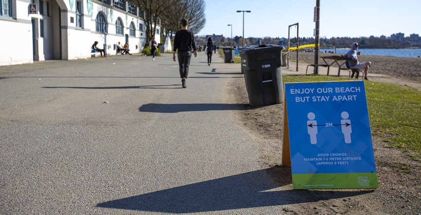 A public notice in Vancouver's English Bay advises pedestrians to stay two metres apart to help prevent the spread of COVID-19. Image: GoToVan/Flickr