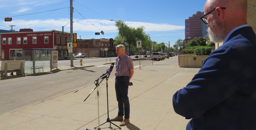 AUPE president Guy Smith addresses media at the Edmonton Court House this morning as the union's lawyer, Patrick Nugent, looks on. Image: AUPE