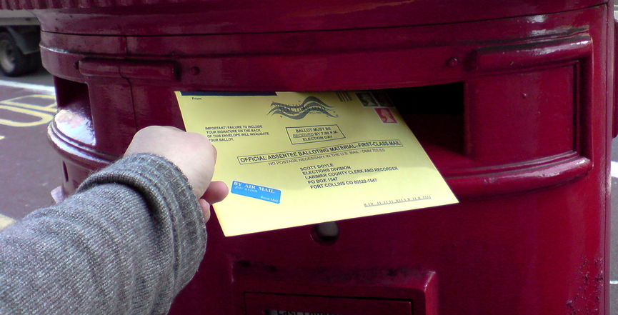 An American voter posts their ballot from overseas. Image: Jeff Knezovich​/Flickr