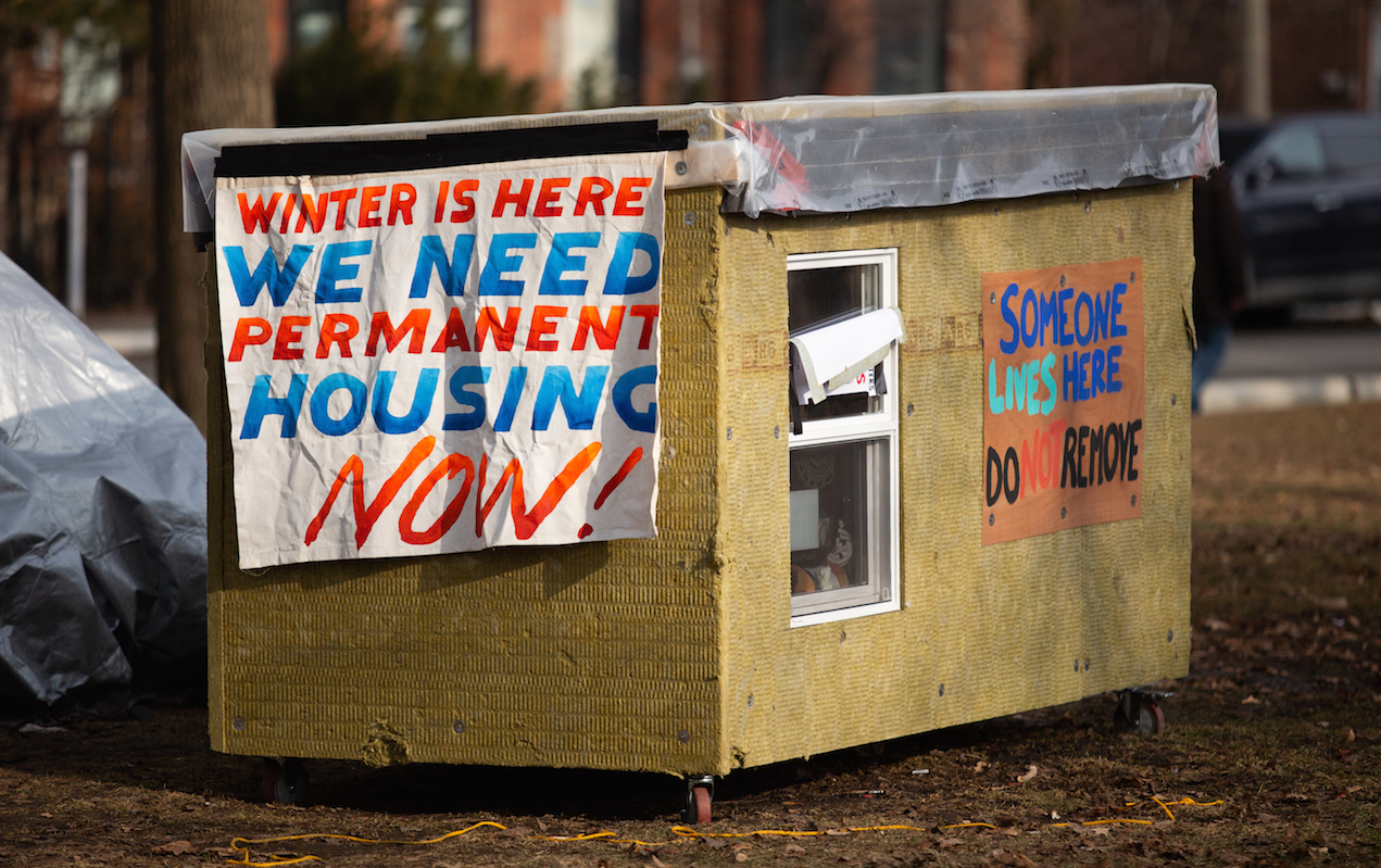 Wooden tiny shelter built by Khaleel Seivwright. A sign on the house says "Someone lives here, do not remove." Image credit: Jeff Bierk