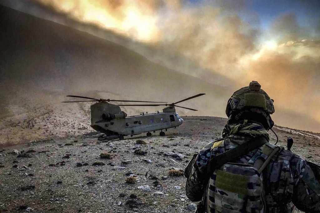 An soldier observes a CH-47 Chinook helicopter at an undisclosed location in Afghanistan, Feb. 9, 2018. Image credit: The U.S. Army/Flickr