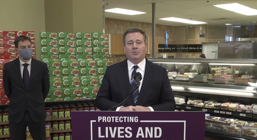 Alberta Premier Jason Kenney in the cake section during yesterday's news conference. Image credit: Video screenshot/Government of Alberta