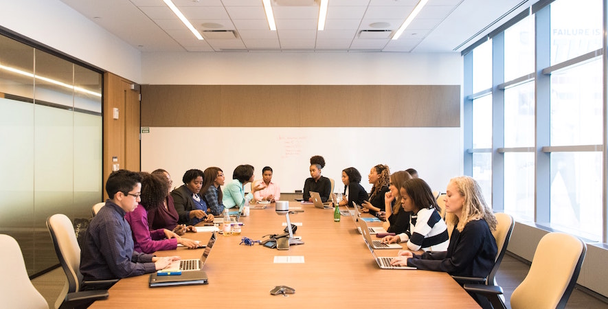 People sitting around boardroom table. Image credit: Christina @ wocintechchat.com/Unsplash