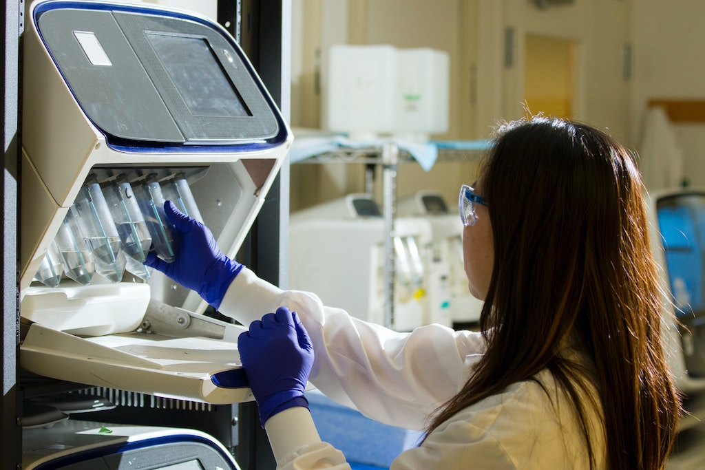 Woman holding test tubes. Image credit: National Cancer Institute/Unsplash