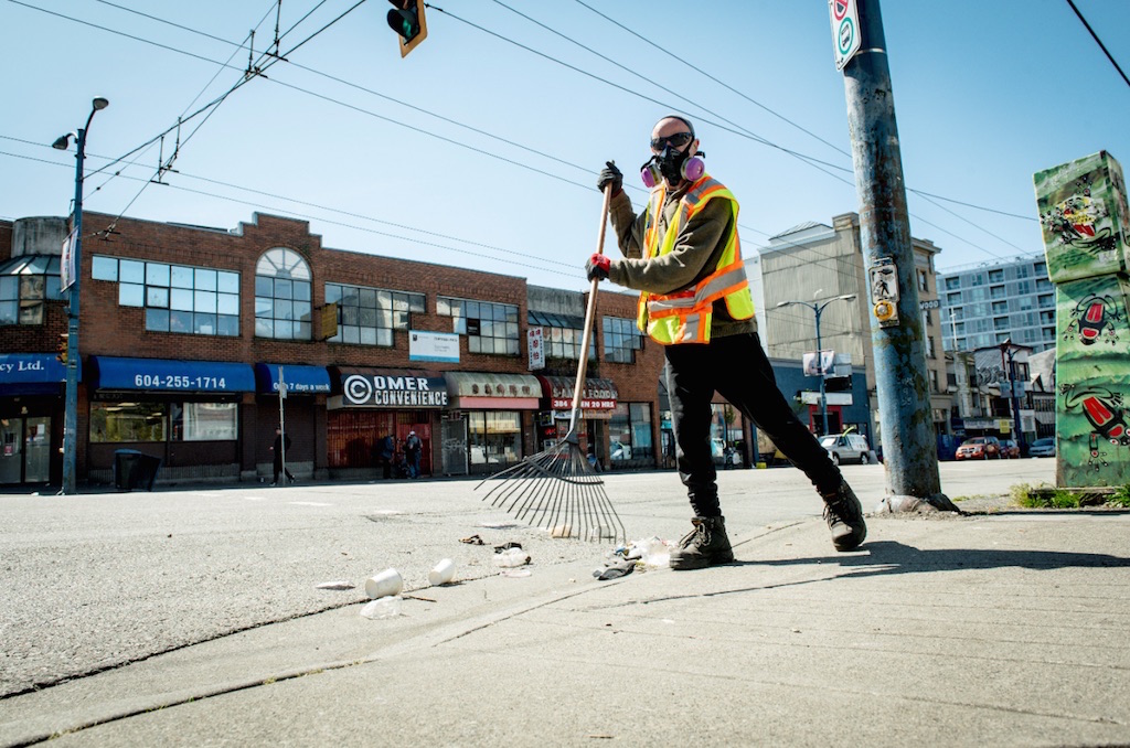 Worker cleans street in Vancouver's Downtown Eastside neighbourhood. Image credit: Josh Berson/BC Labour Heritage Centre