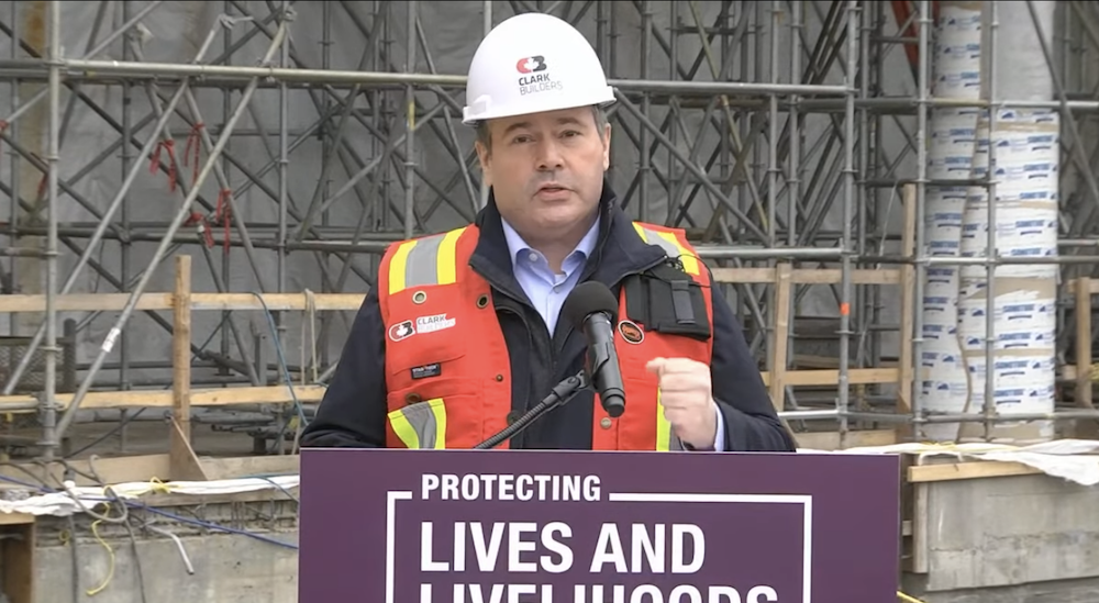 Jason Kenney, dressed up in his construction worker duds, at his news conference Monday. Image: Screenshot of Alberta government video