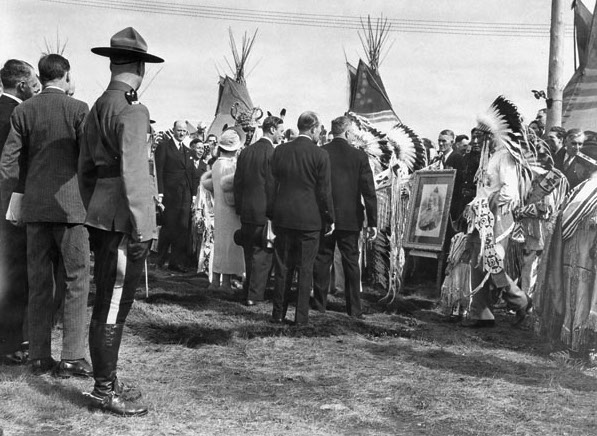 George VI and Queen Elizabeth greet chieftains of the Stoney Indian Tribe in Calgary, who have brought a photo of Queen Victoria, 1939. Image credit: National Film Board of Canada/Wikimedia Commons