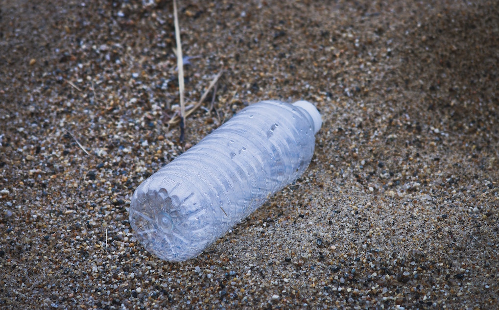 Plastic water bottle on the ground. Image credit: Brian Yurasits/Unsplash