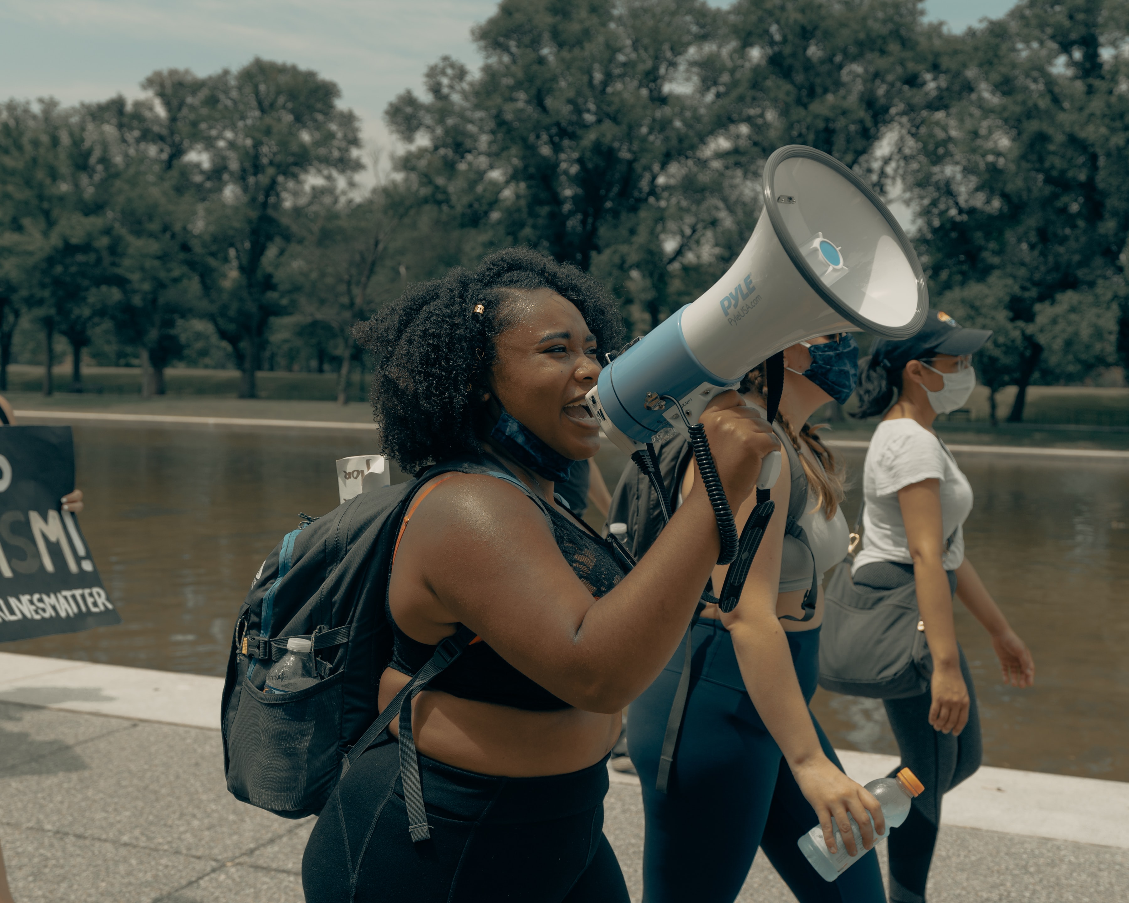 Protest marchers with megaphone. Image credit: Clay Banks/Unsplash