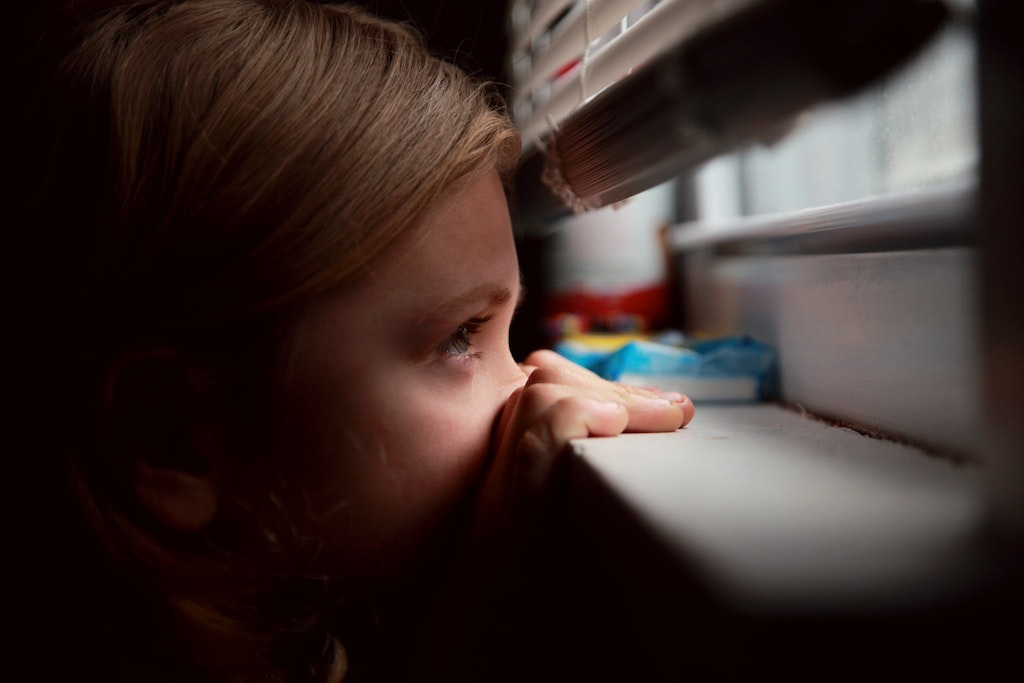 Young person looking out a window. Image credit: Sharon McCutcheon/Unsplash