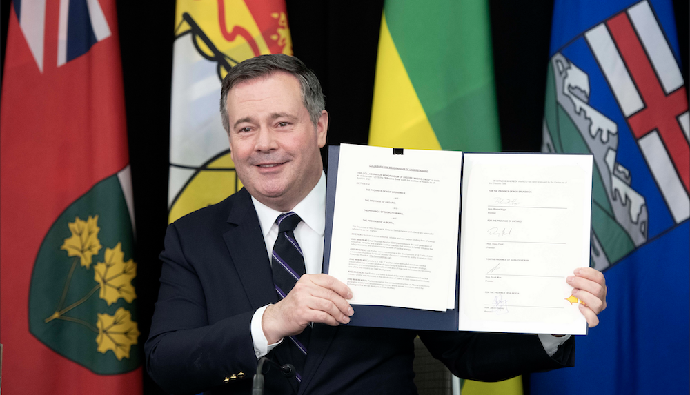 Alberta Premier Jason Kenney displays the speculative agreement he had just signed promising to promote "small modular reactors." Image credit: Chris Schwarz/Government of Alberta/Flickr
