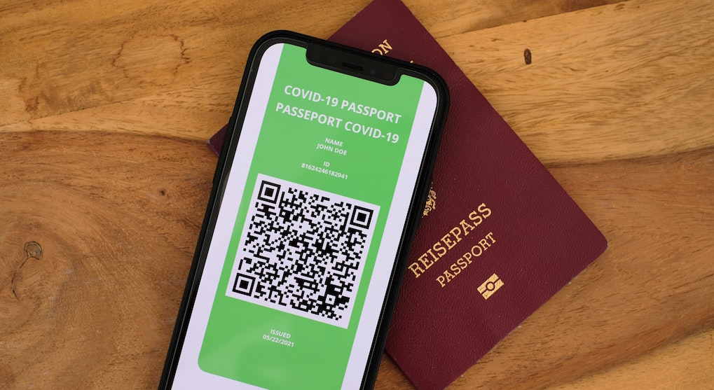 Mobile phone with screen showing what digital COVID passport might look like. Image credit: Lukas/Unsplash