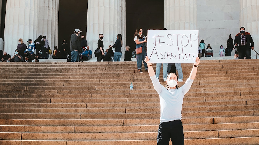 Person holds sign reading "Stop Asian Hate." Image credit: Viviana Rishe/Unsplash