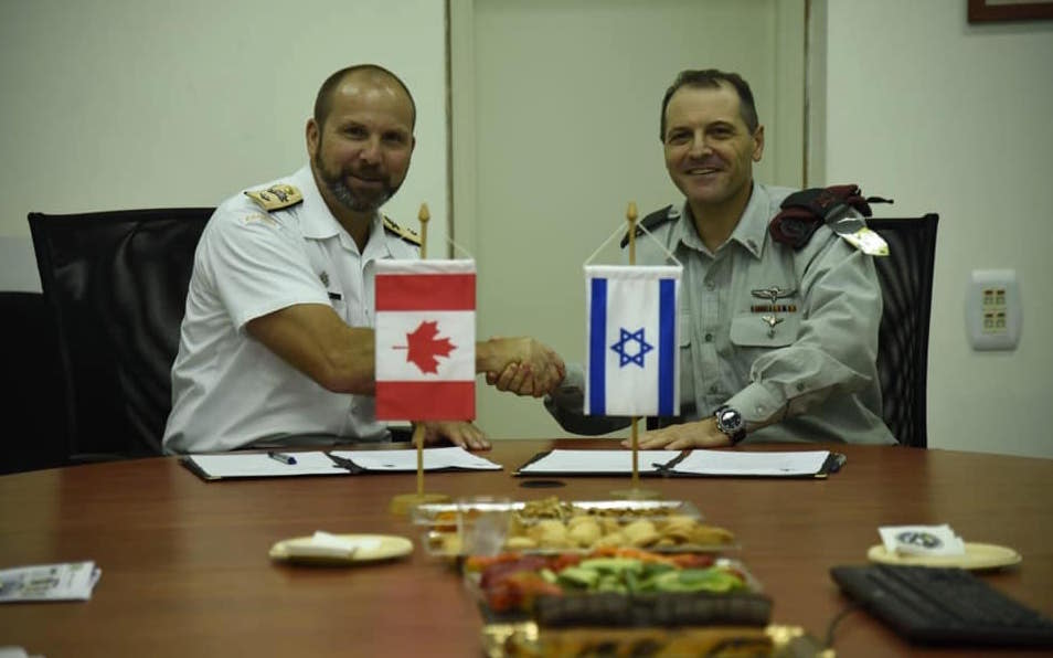 Bradley Peats, the Director General of Strategic Planning, Canadian Armed Forces, signs the IDF-CAF annual work-plan, 2019. Image credit: IDF Spokesperson's Unit/Wikimedia Commons. CC BY-SA 3.0.