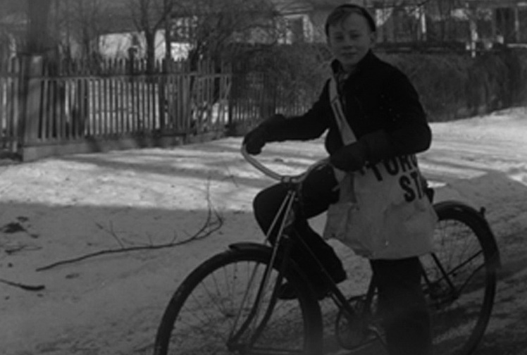 A boy on a bicycle with a Toronto Star newspaper carrier bag in Whitby, Ontario, 1940. Image credit: Marjorie Georgina Ruddy/Wikimedia Commons