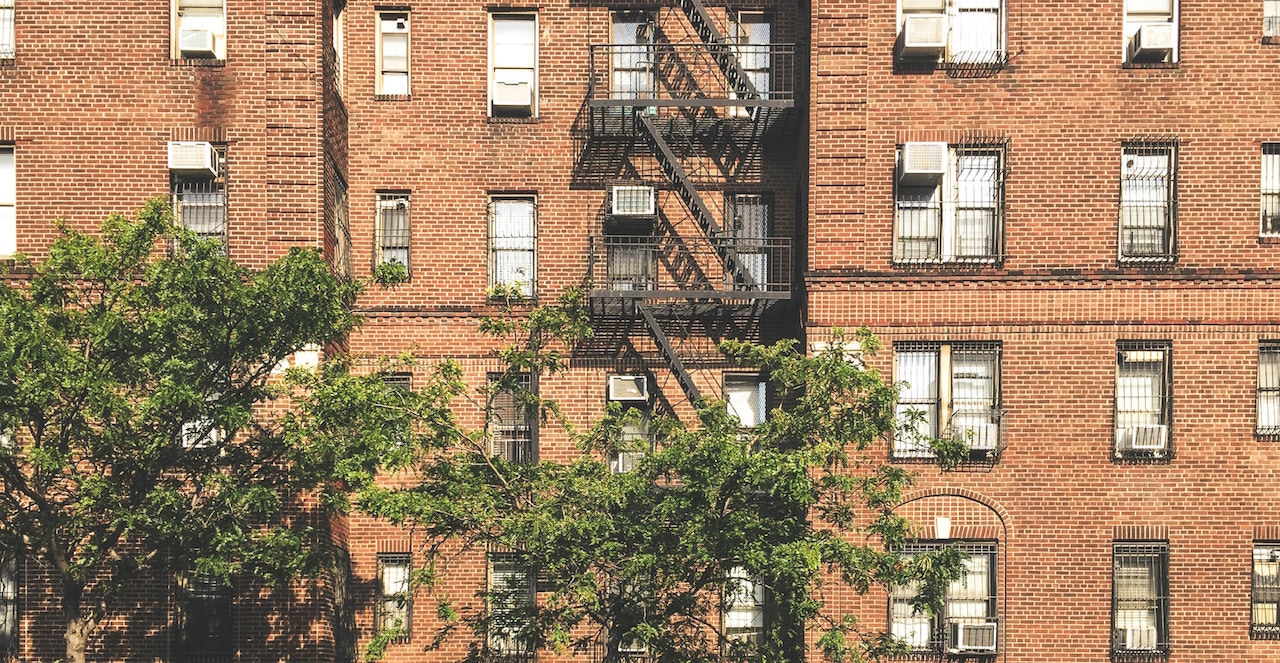 Brick front of apartment building. Image credit: Mo/Unsplash