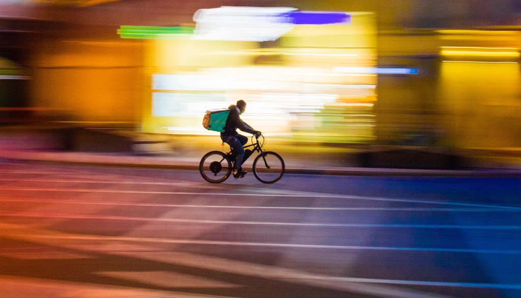 Person on bicycle with food delivery case. Image credit: Paolo Feser/Unsplash