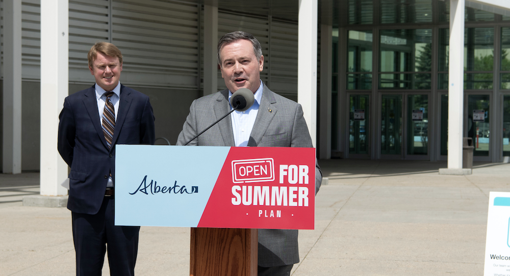 Alberta Health Minister Tyler Shandro wilts in the sun as Premier Jason Kenney carries on about Alberta's vaccination lottery Image credit: Chris Schwarz/Government of Alberta.