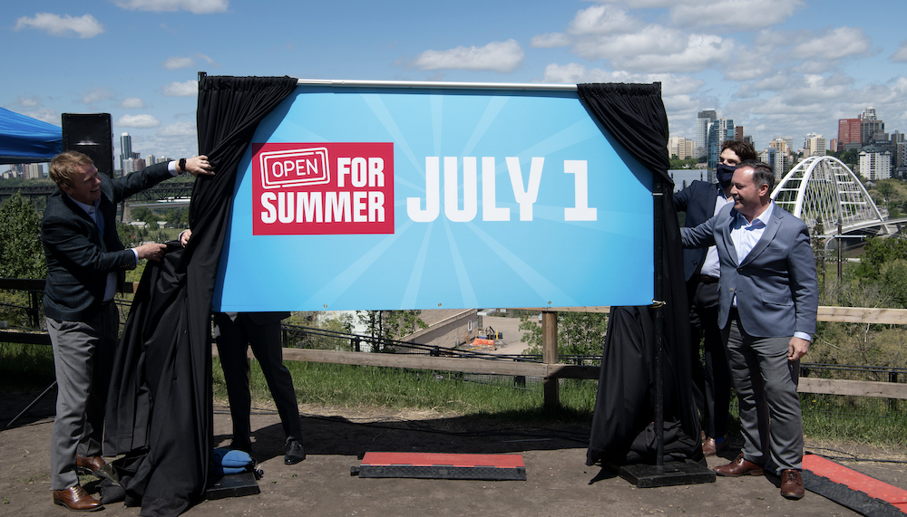 Alberta Premier Jason Kenney and Health Minister Tyler Shandro, both grinning, confirm what Albertans already knew -- we'll be reopening in time for the Calgary Stampede (Image credit: Chris Schwarz/Government of Alberta).