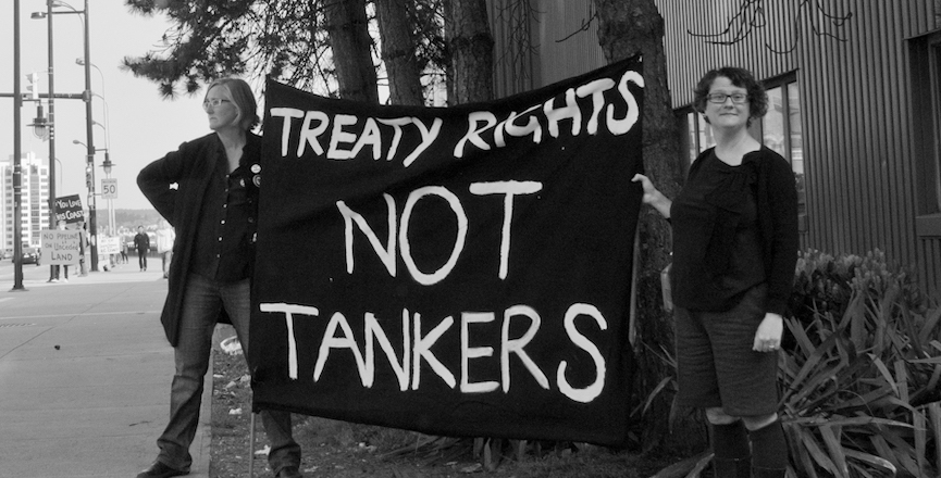 Two people hold a sign that reads "treaty rights not tankers." Image: somecanuckchick/Flickr