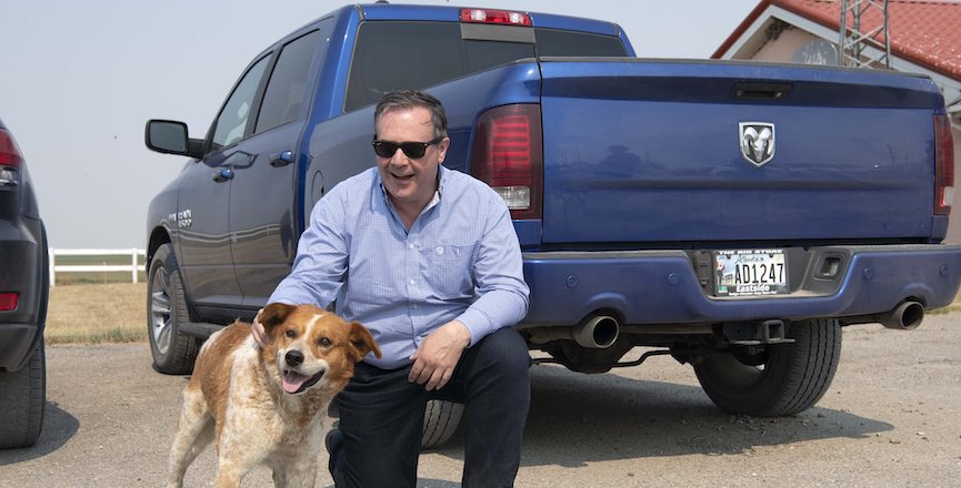 Jason Kenney with a dog and his Conservative blue RAM pick-up truck. Image: Jason Kenney/Twitter