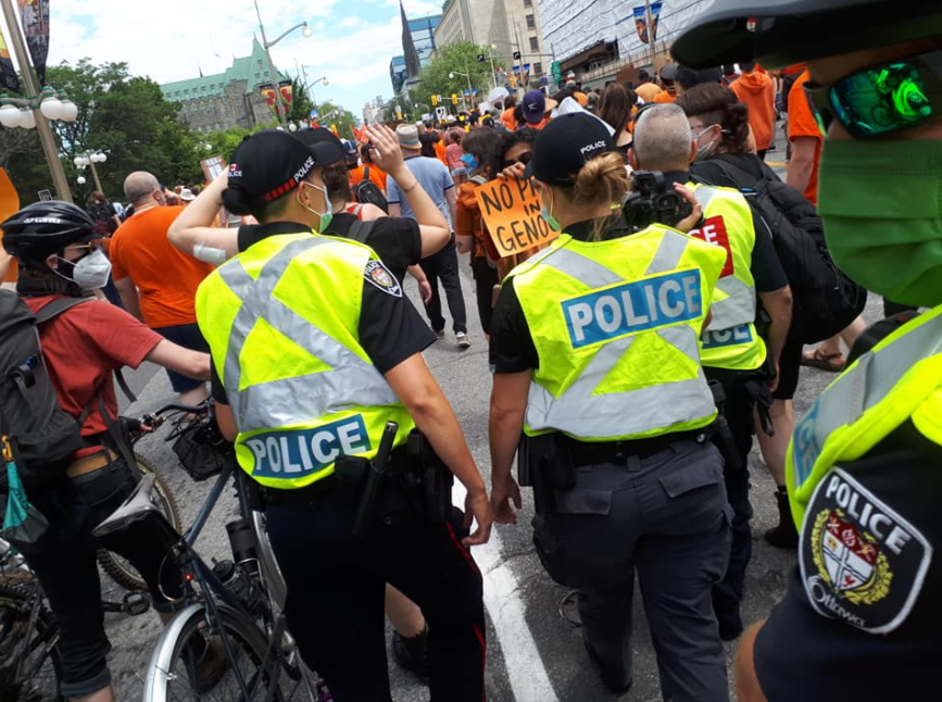 Ottawa Police Services filming a gathering of some 8,000 people mourning the loss of Indigenous children. Image: Brent Patterson/Used with permission