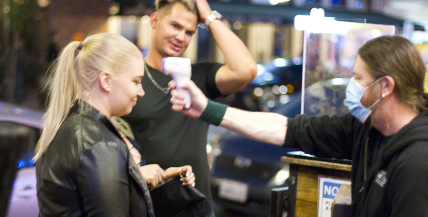 A temperature check before entry to a San Diego bar. Image: Nathan Rupert/Flickr