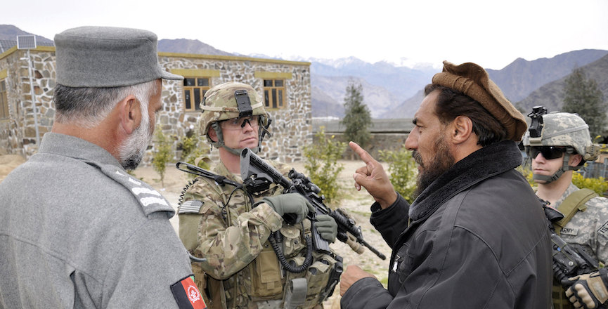 A U.S. soldier speaks with an Afghan man in 2011. Image: U.S. Army/Flickr