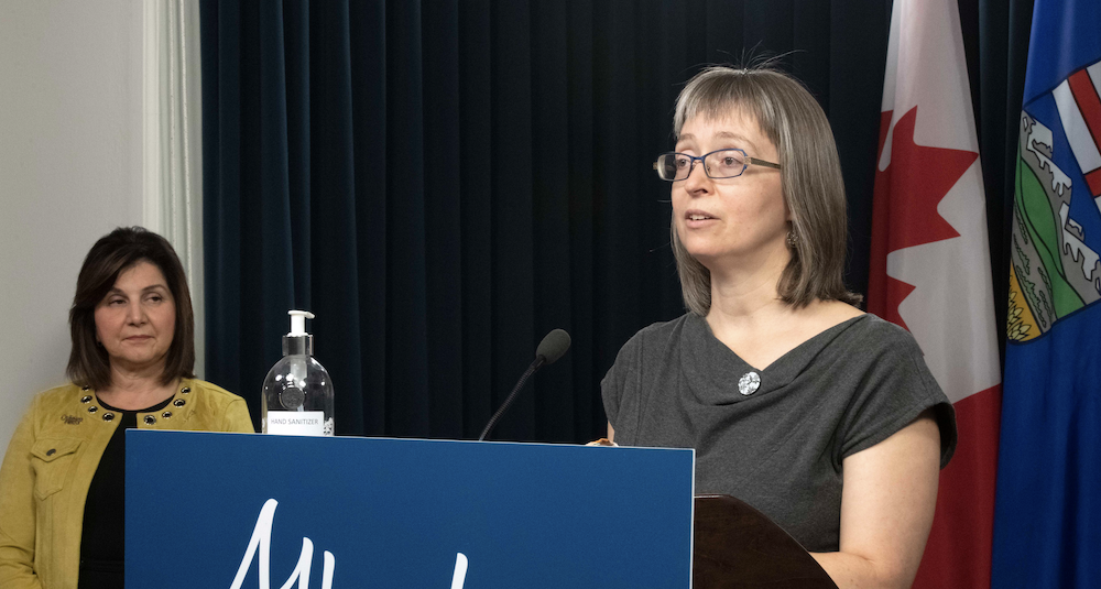 Alberta Chief Medical Officer of Health Dr. Deena Hinshaw walks back the plan to end COVID testing and tracing in Alberta as Education Minister Adriana LaGrange looks on at Friday's news conference (Image: Alberta Newsroom/Flickr).