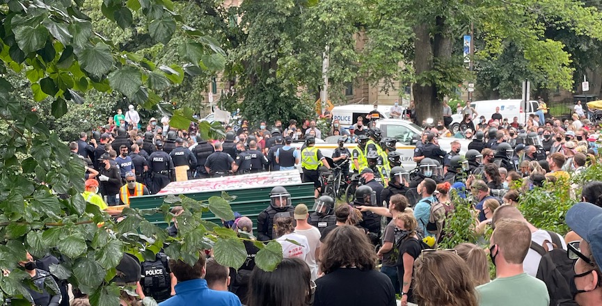 Police tear down an encampment in a Halifax park as protestors look on, August 18, 2021. Image: Kate Higginson/Used with permission