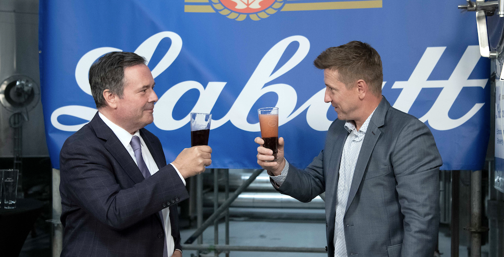 Jason Kenney hoists a glass of something with Labatt's CEO Kyle Norrington at the brewer's Edmonton facility on Aug. 9, that last time anyone saw the Alberta premier in person (Photo: Alberta Newsroom/Flickr).