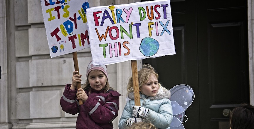 Two children hold up signs at the global climate strike in London, England, 2019. Image: Garry Knight/Flickr