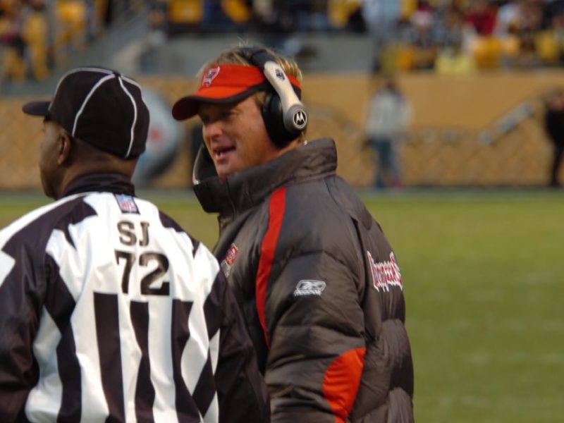 Jon Gruden talking to a Black referee. (Image: Creative Commons)