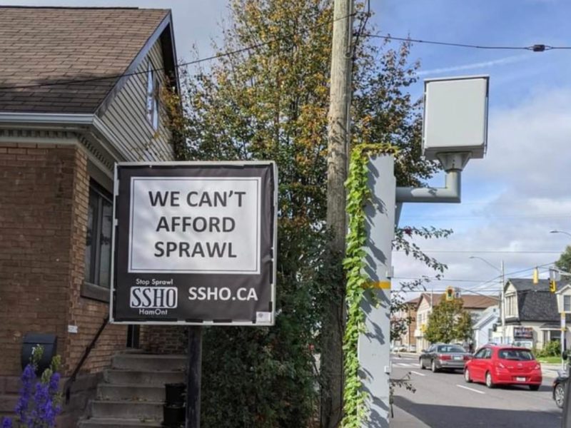 Sign reading "We Can't Afford Urban Sprawl" from Stop Sprawl Hamilton Ontario.