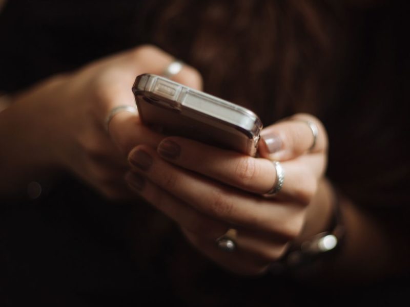 A person holds a phone. (Image: Priscilla DuPreez/Unsplash)