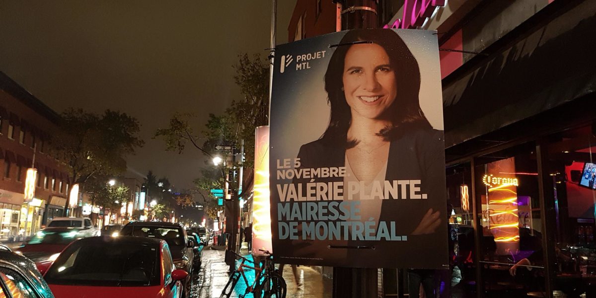 A Valérie Plante campaign sign from the 2017 Montreal municipal election on Rue Sainte-Catherine E at night.